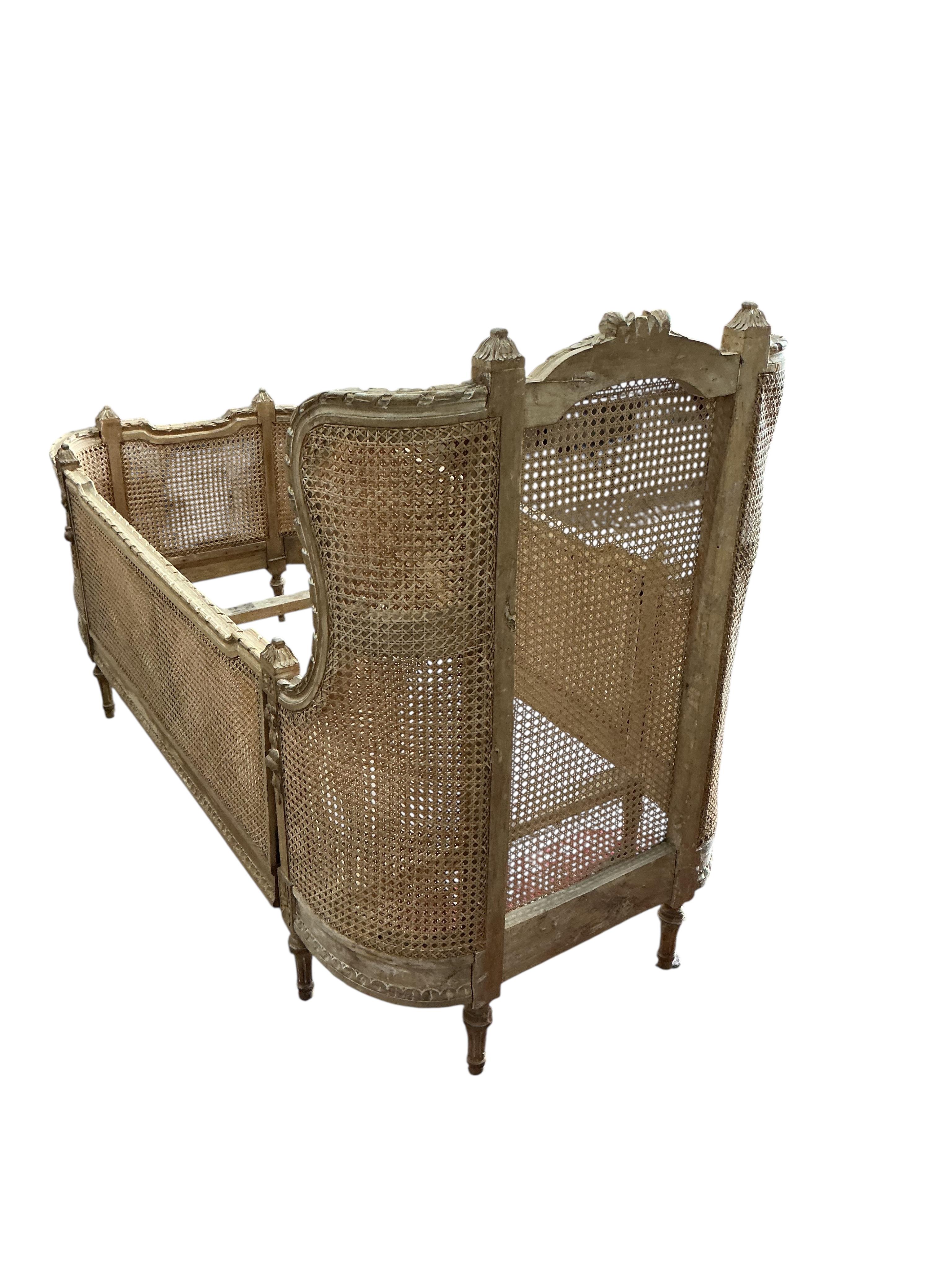 A Louis XVI style caned beech child's bed frame, width 71cm, height 105cm